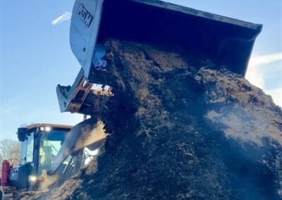 Roll out high tip bucket turning compost