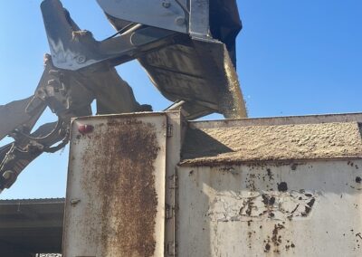 Roll out high tip bucket loading feed